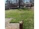 Green backyard surrounded by trees, offering a private outdoor space at 1111 Pondella Dr # 66, Charlotte, NC 28213
