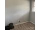 Bedroom with light gray walls, light gray wood grain flooring, and a window at 1111 Pondella Dr # 66, Charlotte, NC 28213