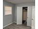 Bedroom with light gray walls, light gray wood grain flooring, closet, and window at 1111 Pondella Dr # 66, Charlotte, NC 28213