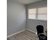 Bedroom with light gray walls, light gray wood grain flooring, and a window at 1111 Pondella Dr # 66, Charlotte, NC 28213