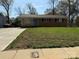 Charming single-story brick home with a well-maintained lawn and a bright blue front door at 1111 Pondella Dr # 66, Charlotte, NC 28213