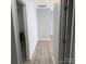 Hallway featuring light gray walls and light gray wood grain flooring at 1111 Pondella Dr # 66, Charlotte, NC 28213