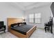 Bright bedroom features a wooden bed frame, a window, and carpeted floors at 1129 Doveridge St, Charlotte, NC 28273