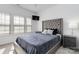 Modern bedroom with a tufted headboard and natural light from the windows at 1129 Doveridge St, Charlotte, NC 28273