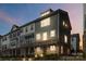 Charming townhome showcasing brick facade, warm lighting, and well-maintained landscaping at 1129 Doveridge St, Charlotte, NC 28273
