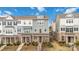 View of colorful townhomes with a brick and siding exterior and landscaped front yards at 1129 Doveridge St, Charlotte, NC 28273