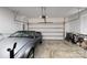 Clean and organized two-car garage with a parked vehicle and storage at 1129 Doveridge St, Charlotte, NC 28273