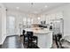 Open kitchen with large island, stainless appliances and dark hardwood floors at 1129 Doveridge St, Charlotte, NC 28273