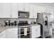Bright kitchen features white cabinets, granite countertops, and stainless steel appliances at 1129 Doveridge St, Charlotte, NC 28273