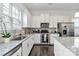 Bright kitchen features white cabinets, granite countertops, stainless steel appliances, and dark hardwood flooring at 1129 Doveridge St, Charlotte, NC 28273