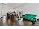 View of open living room and kitchen featuring dark hardwood floors and natural light at 1129 Doveridge St, Charlotte, NC 28273