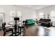 Bright living room with dark hardwood floors, a round glass coffee table, and large sunny windows at 1129 Doveridge St, Charlotte, NC 28273