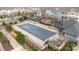 Aerial view of a rectangular neighborhood pool covered with a net and many chairs and tables surrounding it at 1129 Doveridge St, Charlotte, NC 28273