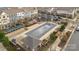 Aerial view of a rectangular neighborhood pool covered with a net and surrounded by seating areas and landscaping at 1129 Doveridge St, Charlotte, NC 28273