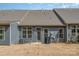 Exterior shot of backyard area, featuring patio, well-maintained siding, and a grassy lawn at 125 Lanyard Dr # E, Mooresville, NC 28117