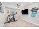 Modern bedroom featuring a stationary bike and mounted television perfect for a home gym at 125 Lanyard Dr # E, Mooresville, NC 28117