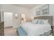 Bright bedroom featuring white walls, ensuite bathroom access, and stylish coastal decor at 125 Lanyard Dr # E, Mooresville, NC 28117