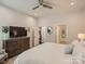 Cozy bedroom showcasing neutral colors, a ceiling fan, and ensuite bathroom access at 125 Lanyard Dr # E, Mooresville, NC 28117