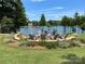Lakeside fire pit with seating, surrounded by lush greenery, for gatherings and relaxation at 125 Lanyard Dr # E, Mooresville, NC 28117