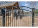 Elegant black iron gate welcomes you to the waterfront with a brick pathway and sheltered area at 125 Lanyard Dr # E, Mooresville, NC 28117