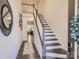 Inviting entryway featuring staircase with dark trim, a decorative rug, and neutral walls at 125 Lanyard Dr # E, Mooresville, NC 28117