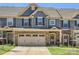 Charming townhome with a stone facade, two-car garage, and well-manicured lawn at 125 Lanyard Dr # E, Mooresville, NC 28117