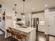 Modern kitchen with white cabinets, stainless steel appliances, and a breakfast bar with seating at 125 Lanyard Dr # E, Mooresville, NC 28117