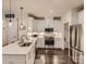Contemporary kitchen featuring white cabinetry, stainless steel appliances, and a view of a breakfast nook at 125 Lanyard Dr # E, Mooresville, NC 28117