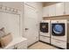 Well-organized laundry room featuring modern washer and dryer units and built in storage with bench seating at 125 Lanyard Dr # E, Mooresville, NC 28117