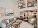 Open-concept living room with high ceilings, a comfortable sofa, and access to dining area and kitchen at 125 Lanyard Dr # E, Mooresville, NC 28117