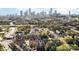 An aerial view showing the neighborhood and the city skyline in the background at 1525 Walnut View Dr, Charlotte, NC 28208