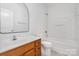 Functional bathroom featuring a classic vanity, toilet, and tub-shower combo at 1525 Walnut View Dr, Charlotte, NC 28208