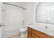 Clean bathroom featuring a bathtub, shower, and a wood-trimmed vanity at 1525 Walnut View Dr, Charlotte, NC 28208