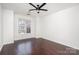 Bright bedroom featuring hardwood floors, a ceiling fan, and a window view at 1525 Walnut View Dr, Charlotte, NC 28208