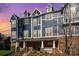 Striking blue townhouse exterior with brick facade and inviting covered entry at 1525 Walnut View Dr, Charlotte, NC 28208