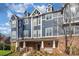 Attractive blue townhouse with brick base, complemented by well-maintained landscaping at 1525 Walnut View Dr, Charlotte, NC 28208
