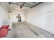 Spacious garage with concrete floors and ample storage space for vehicles and equipment at 1525 Walnut View Dr, Charlotte, NC 28208