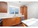 Well-lit kitchen featuring wooden cabinets, stainless steel appliances, and white countertops at 1525 Walnut View Dr, Charlotte, NC 28208