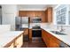 Kitchen featuring stainless steel appliances, wooden cabinets, and hardwood floors at 1525 Walnut View Dr, Charlotte, NC 28208