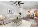 Inviting living room with hardwood floors, a ceiling fan, and access to dining and kitchen at 1525 Walnut View Dr, Charlotte, NC 28208
