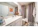 Updated bathroom with modern vanity, shower with patterned curtains, and decor at 15308 Lake Ridge Rd, Charlotte, NC 28278