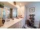 Bright bathroom featuring double sinks, framed mirror, and storage shelves at 15308 Lake Ridge Rd, Charlotte, NC 28278