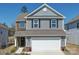 Charming two-story home features a two-car garage, brick and siding accents, and a well-maintained front yard at 15308 Lake Ridge Rd, Charlotte, NC 28278