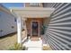 Inviting front door with decorative wreath and covered porch, adding a touch of elegance to the entryway at 15308 Lake Ridge Rd, Charlotte, NC 28278