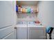 Functional laundry area with modern washer and dryer, and shelving for storage at 15308 Lake Ridge Rd, Charlotte, NC 28278