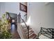 Elegant staircase with wooden steps and decorative iron railing, adding character to the home's interior at 15308 Lake Ridge Rd, Charlotte, NC 28278