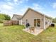 Backyard showcasing a cozy patio area, fenced perimeter, and lush green grass at 163 Brookshire Dr, Fort Mill, SC 29715
