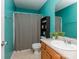 Bright bathroom featuring a vanity with wooden cabinets, tiled floors, and blue accent wall at 163 Brookshire Dr, Fort Mill, SC 29715