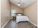Cozy bedroom with a ceiling fan, neutral walls, and wood-look flooring at 163 Brookshire Dr, Fort Mill, SC 29715