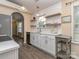 Bright kitchen featuring white cabinets, subway tile backsplash, and open shelving for storage at 163 Brookshire Dr, Fort Mill, SC 29715